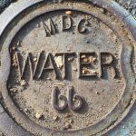 A photograph of a MDC water line cover