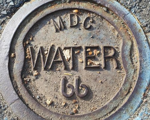 A photograph of a MDC water line cover