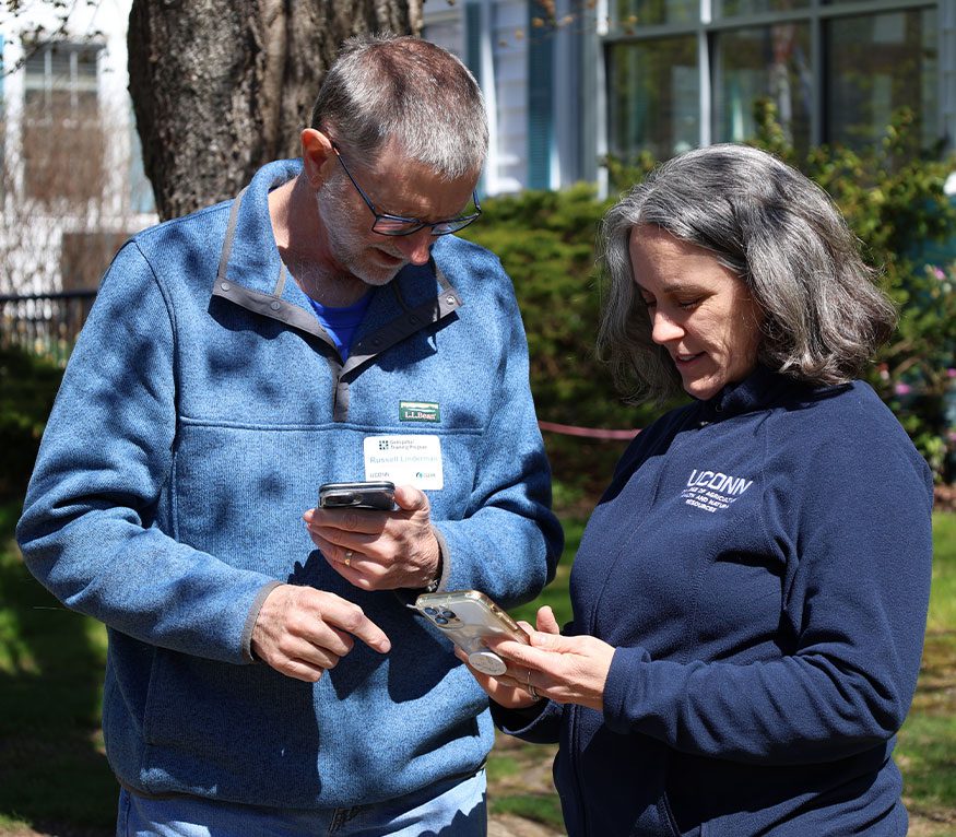 Extension Faculty showing a geospatial training participant a phone app