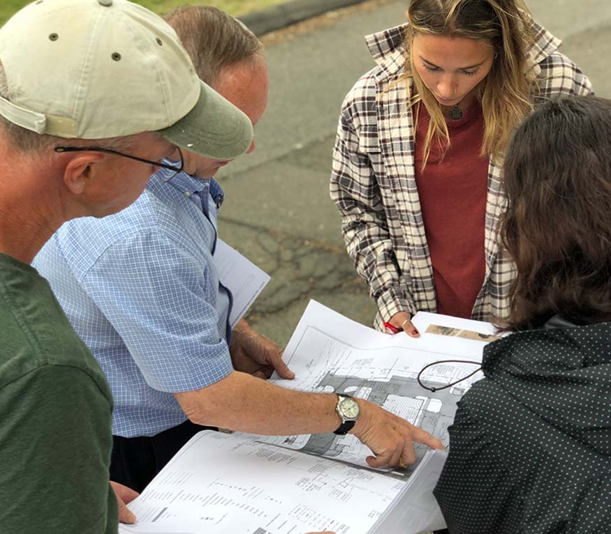 stormwater students review a map on a site walk